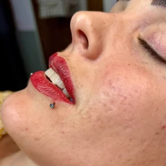 Bold red permanent lip colour, side profile